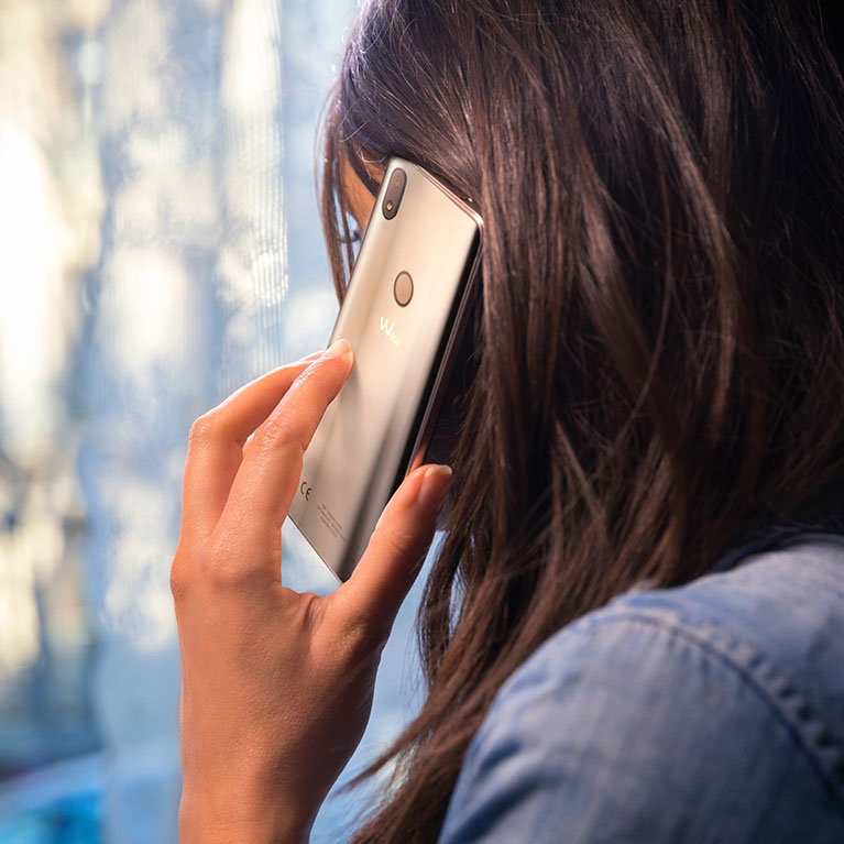 Woman calling someone with a wiko smartphone
