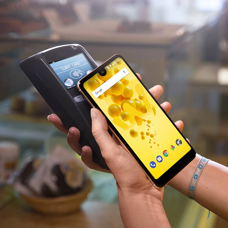 Woman paying with the NFC feature of the View 2 smartphone